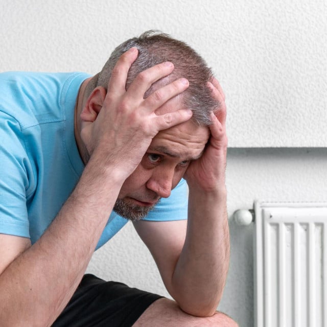 <p>Sad handsome man. Depressed man in light room. Crisis and depression.</p>