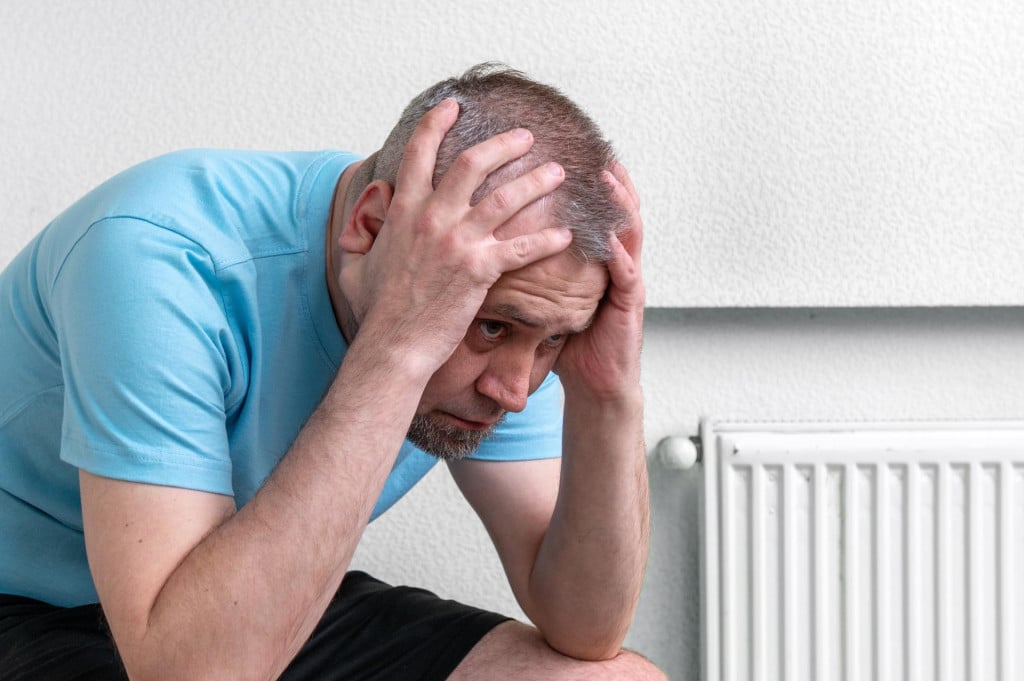 <p>Sad handsome man. Depressed man in light room. Crisis and depression.</p>
