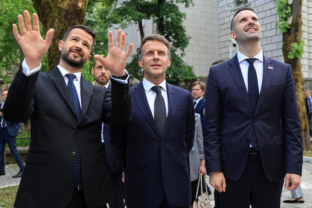 <p>France&lsquo;s President Emmanuel Macron (C) listens to Montenegro&lsquo;s President Jakov Milatovic (L) flanked by Montenegro&lsquo;s Prime Minister Milojko Spajic (R) during his first official visit to Montenegro ahead of the EU-Western Balkans Summit in Cetinje on June 4, 2026. (Photo by Ludovic MARIN/AFP)</p>