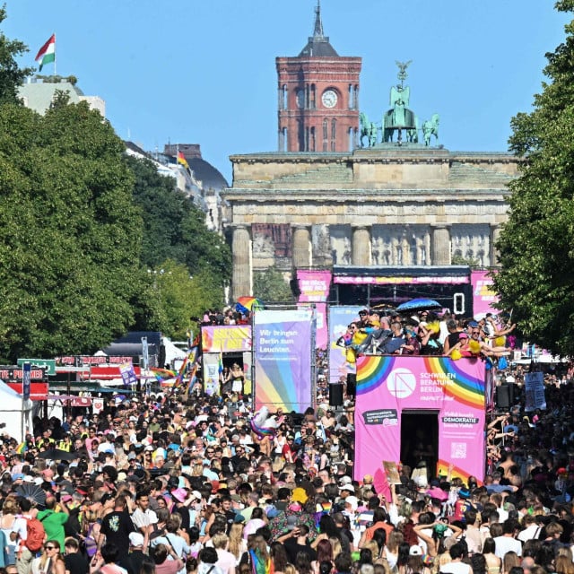 <p>Participants march near the Brandenburg Gate during the Christopher Street Day (CSD) parade in Berlin on July 25, 2026. During this year&lsquo;s CSD parade, taking place under the slogan &lsquo;Taking a stand is Hot&lsquo;, various groups demonstrate in support of diversity, human rights, and the protection of minorities. (Photo by RALF HIRSCHBERGER/AFP)</p>