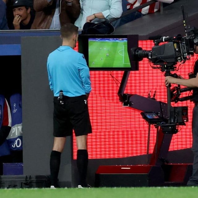 <p>French referee Clement Turpin checks the pitch-side monitor before showing a red card to Barcelona&lsquo;s Spanish defender #24 Eric Garcia (not seen) during the UEFA Champions League quarter final second leg football match between Club Atletico de Madrid and FC Barcelona at Metropolitano Stadium in Madrid on April 14, 2026. (Photo by Oscar DEL POZO/AFP)</p>