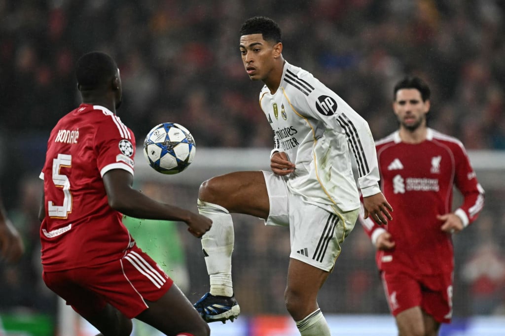 <p>Real Madrid&lsquo;s English midfielder #05 Jude Bellingham (C) vies with Liverpool&lsquo;s French defender #05 Ibrahima Konate (L) during the UEFA Champions League, league phase football match between Liverpool and Real Madrid at Anfield in Liverpool, north west England on November 4, 2025. (Photo by Paul ELLIS/AFP)</p>