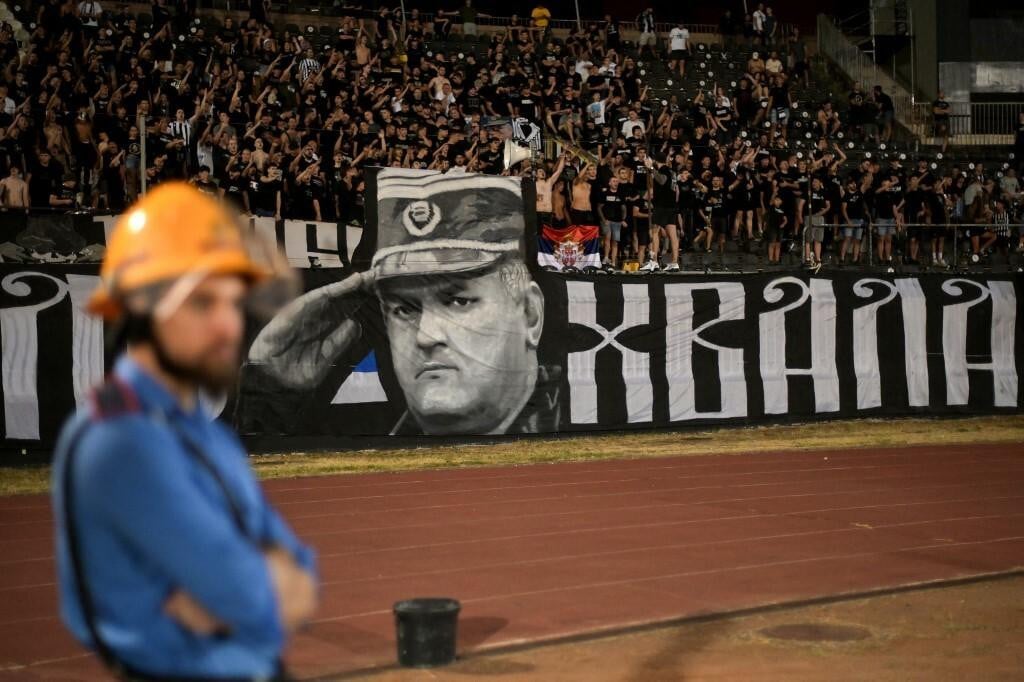 <p>Partizan Belgrade supporters display a banner depicting former Bosnian Serb military chief Ratko Mladic during the Serbian SuperLiga football match between Partizan Belgrade and OFK Beograd in Belgrade on August 31, 2026, days after Mladic died at the age of 84 in a hospital in The Hague. Ratko Mladic, the former Bosnian Serb military chief dubbed the &rdquo;Butcher of Bosnia&rdquo; for his role in the 1995 Srebrenica massacre, has died, Serbian state broadcaster RTS reported on August 27, 2026. (Photo by OLIVER BUNIC/AFP)</p>